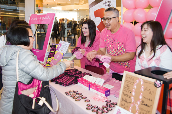 (from right to left): Fairchild Radio DJs Jieying Chen, William Ho and Deborah Moore selling the pink mittens and pink socks for charity.