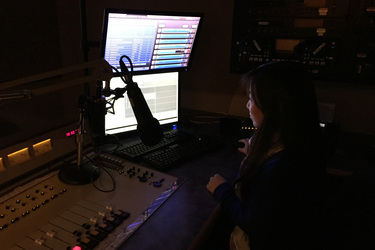 Jieying Chen from CHKG-FM961 in Vancouver continued to do editing for her afternoon program.  There is no window nearby so it was quite dark.