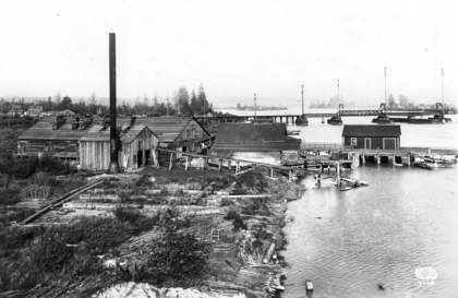 1918 年列治文菲沙河西北岸（現 River Rock Casino），遠望可見連接溫哥華之 Interturban 火車木橋，前景木屋為冰廠凍房。（City of Richmond Archives）